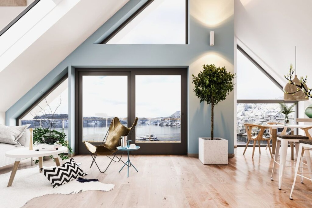 En modern skandinavisk inredning i ett vindsutrymme med ljusa trägolv, minimalistiska möbler och geometriska detaljer.